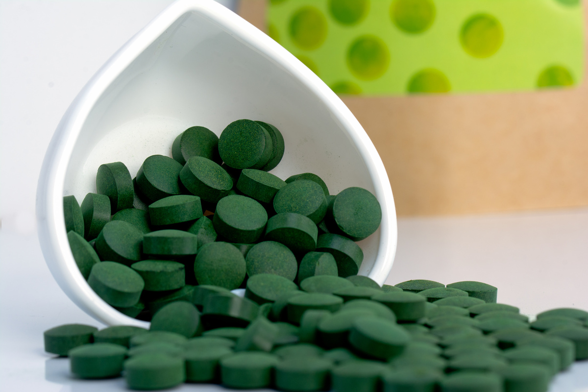 Chlorella or spirulina pills close up. The texture of spirulina or chlorella tablets.