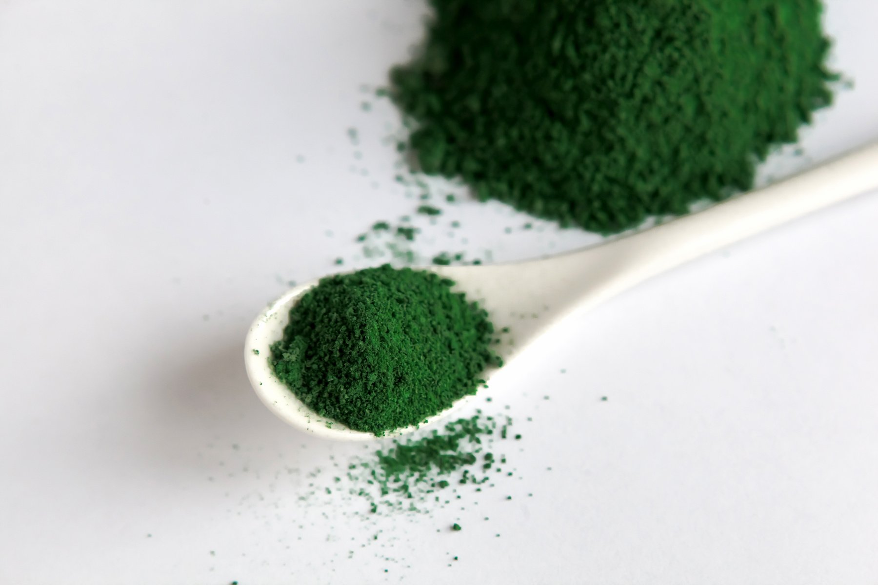 white spoon with Heap of chlorella